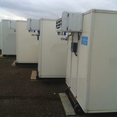 Frostbite Refrigeration technician performing a pre-delivery quality control check on a freezer trailer