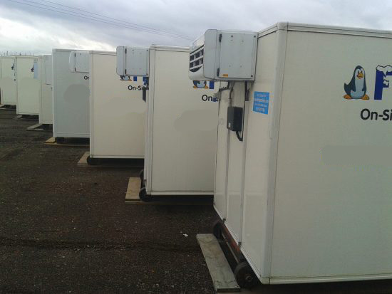 Frostbite Refrigeration technician performing a pre-delivery quality control check on a freezer trailer