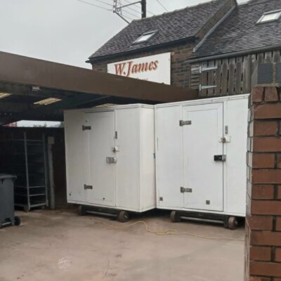 Frostbite Refrigeration team member delivering a clean mobile cold storage unit to a prepared site.