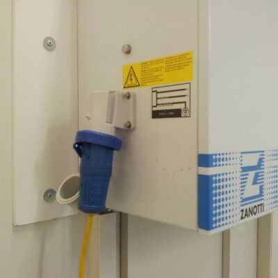 A Frostbite Refrigeration freezer trailer connected to a power supply at a North West event venue.