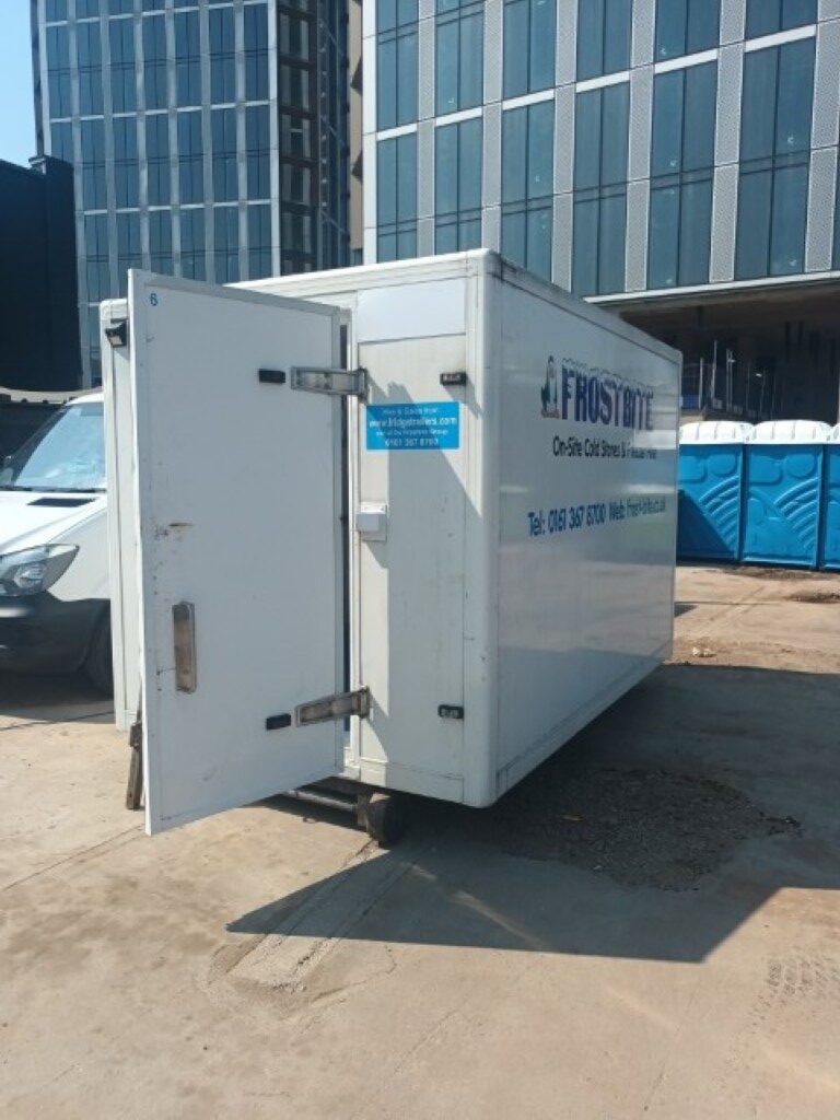 Frostbite Refrigeration technician calibrating a thermal expansion valve for thermodynamic efficiency in a Wigan cold storage facility